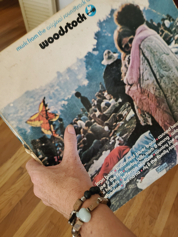 beaded bracelet stack and a Woodstock album